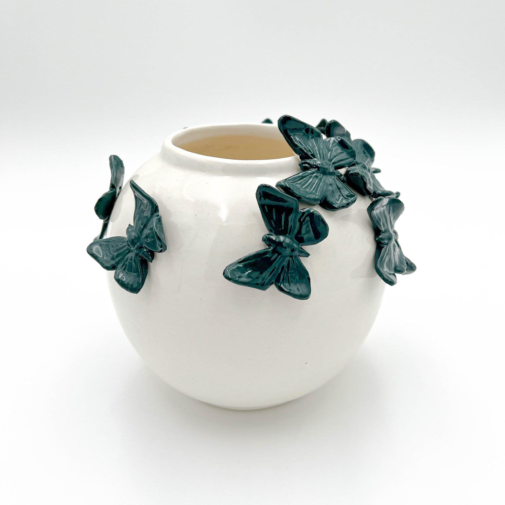 Ivory ceramic vase with hunter green butterflies around its rim